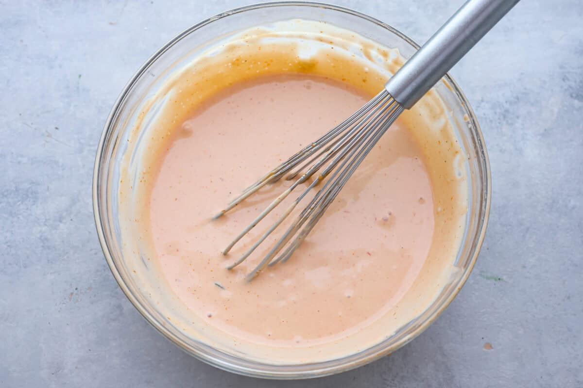 This burger sauce is a game-changer for your cookouts, adding a delicious twist to your favorite meals. Whip it up in minutes and enjoy a flavorful blend thatโs perfect for burgers or as a dip for fries. Top view of the ingredients all whisked together in a glass bowl.
