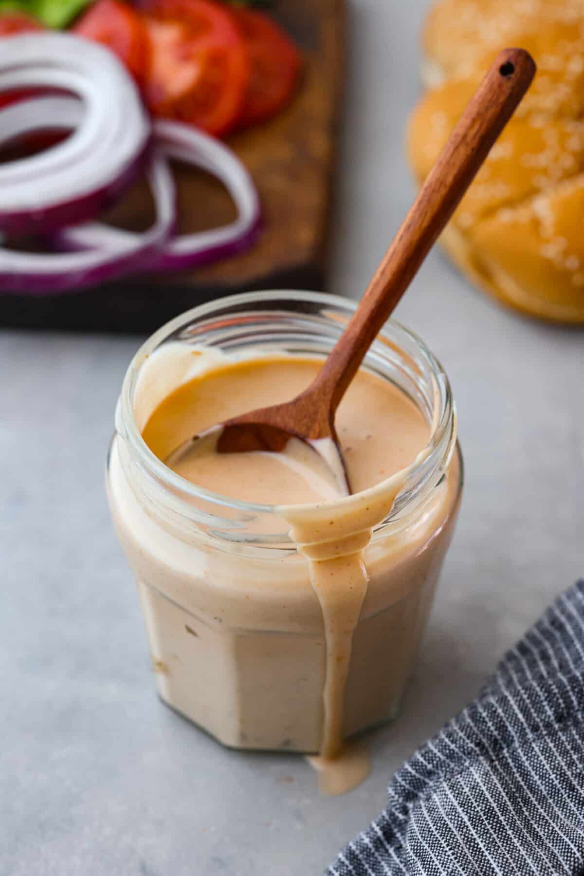 This burger sauce is a game-changer for your cookouts, adding a delicious twist to your favorite meals. Whip it up in minutes and enjoy a flavorful blend thatโs perfect for burgers or as a dip for fries. A close up of a jar of burger sauce.
