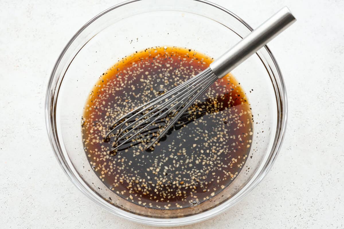 One bite of this grilled bourbon chicken and your tastebuds will be dancing with delight! It's marinated in a flavorful homemade bourbon sauce that tastes amazing. You will be making it on the regular once you see what a huge hit it is! Marinade whisked in a glass bowl.