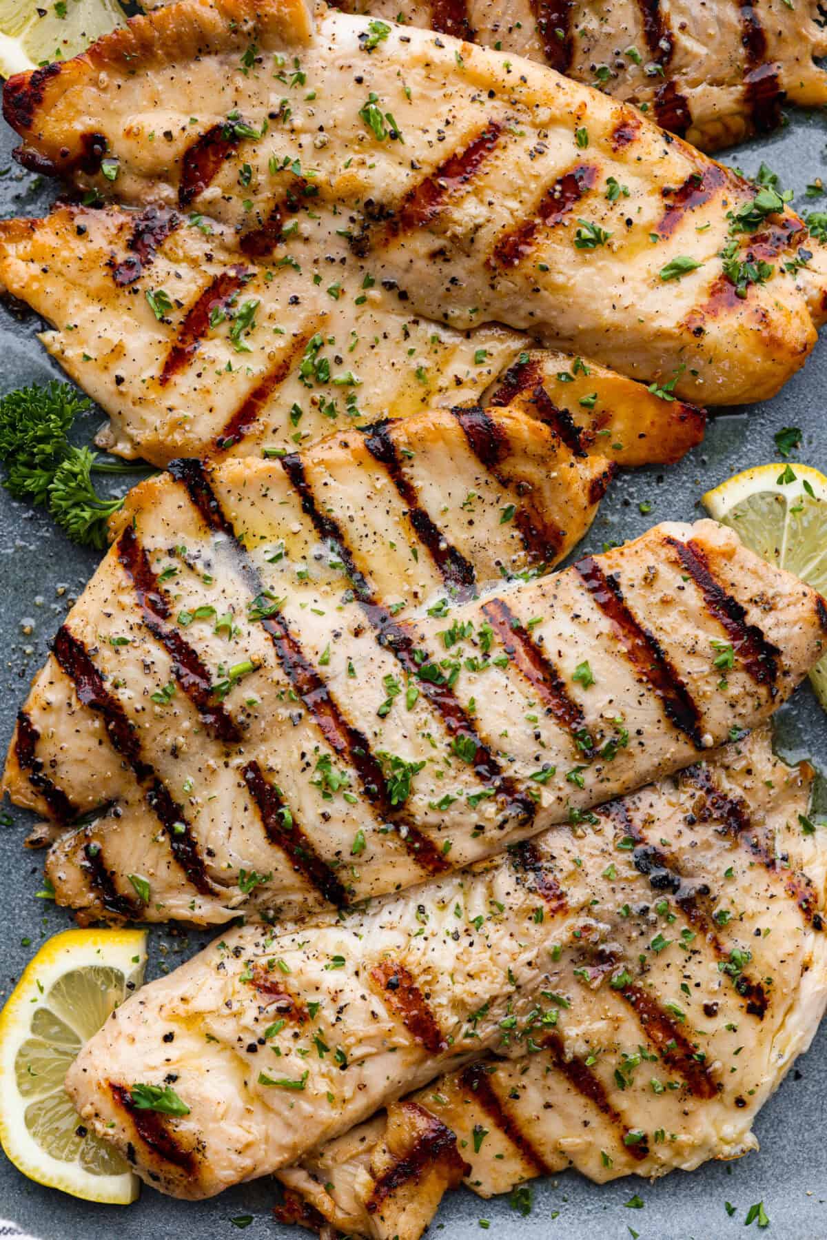 Fire up the grill! This grilled tilapia is deliciously seasoned and has the best flaky texture. Close up of grilled tilapia.