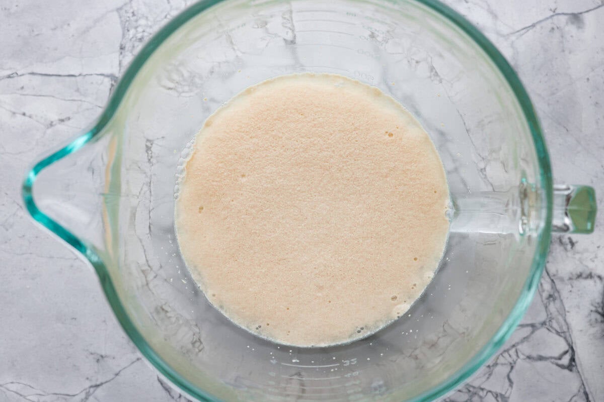 You want to make bread, but where do you start? My beginner's guide to baking bread is here to save the day! Feel confidentย at bread-making while I hold your hand through the whole process. First photo of the first step to baking bread with yeast proofing in a bowl.