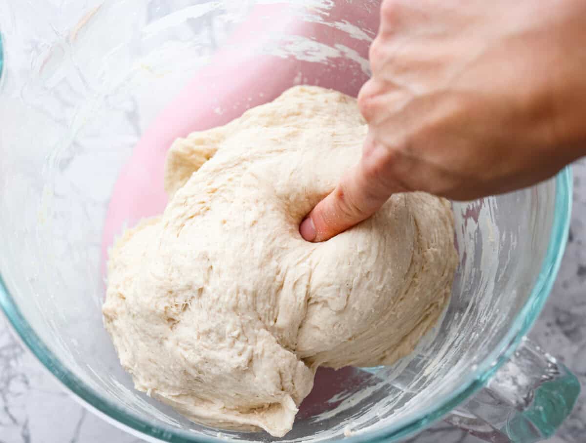 You want to make bread, but where do you start? My beginner's guide to baking bread is here to save the day! Feel confidentย at bread-making while I hold your hand through the whole process. Second photo of the poke test to check if the dough is ready.