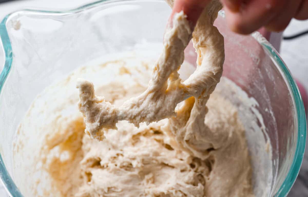 You want to make bread, but where do you start? My beginner's guide to baking bread is here to save the day! Feel confidentย at bread-making while I hold your hand through the whole process. First photo showing sticky dough.