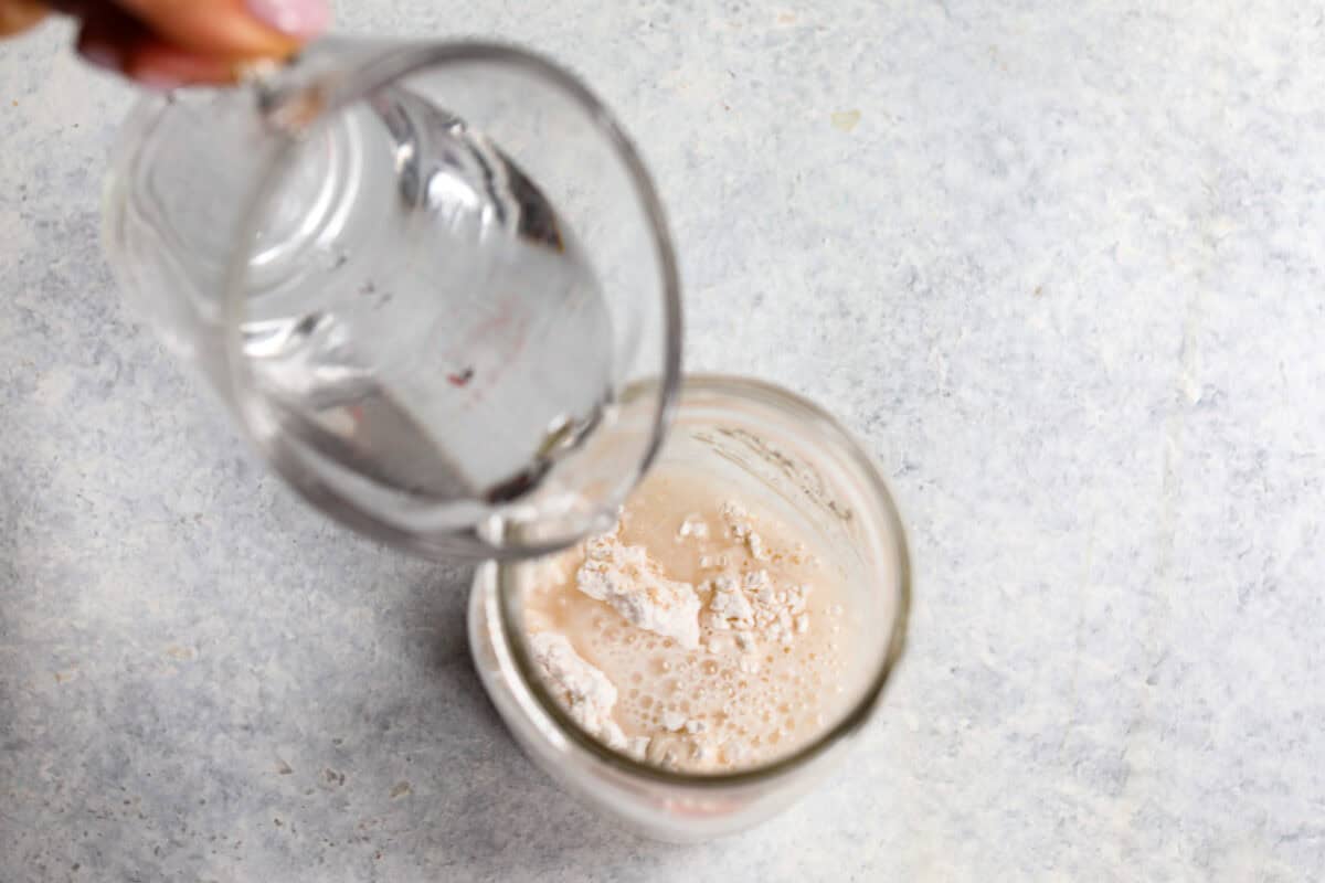 You asked for help with yeast, so I have created a "How to Bake with Yeast" guide just for you! Yeast doesn't have to be intimidating, and I hope that by the end of this post, you will be an expert! water being poured into yeast to show how to bake with it.