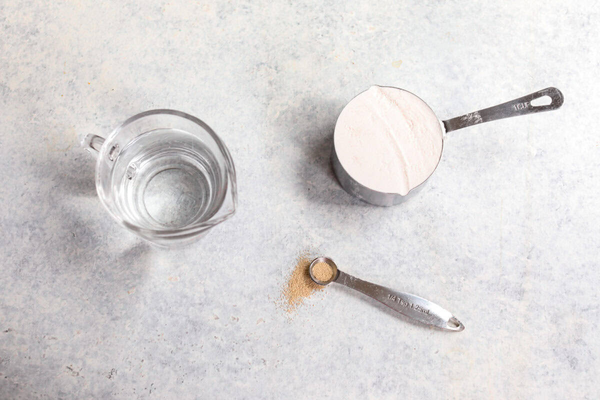 You asked for help with yeast, so I have created a "How to Bake with Yeast" guide just for you! Yeast doesn't have to be intimidating, and I hope that by the end of this post, you will be an expert! top shot of yeast, flour and water measured out to show how to bake with yeast.