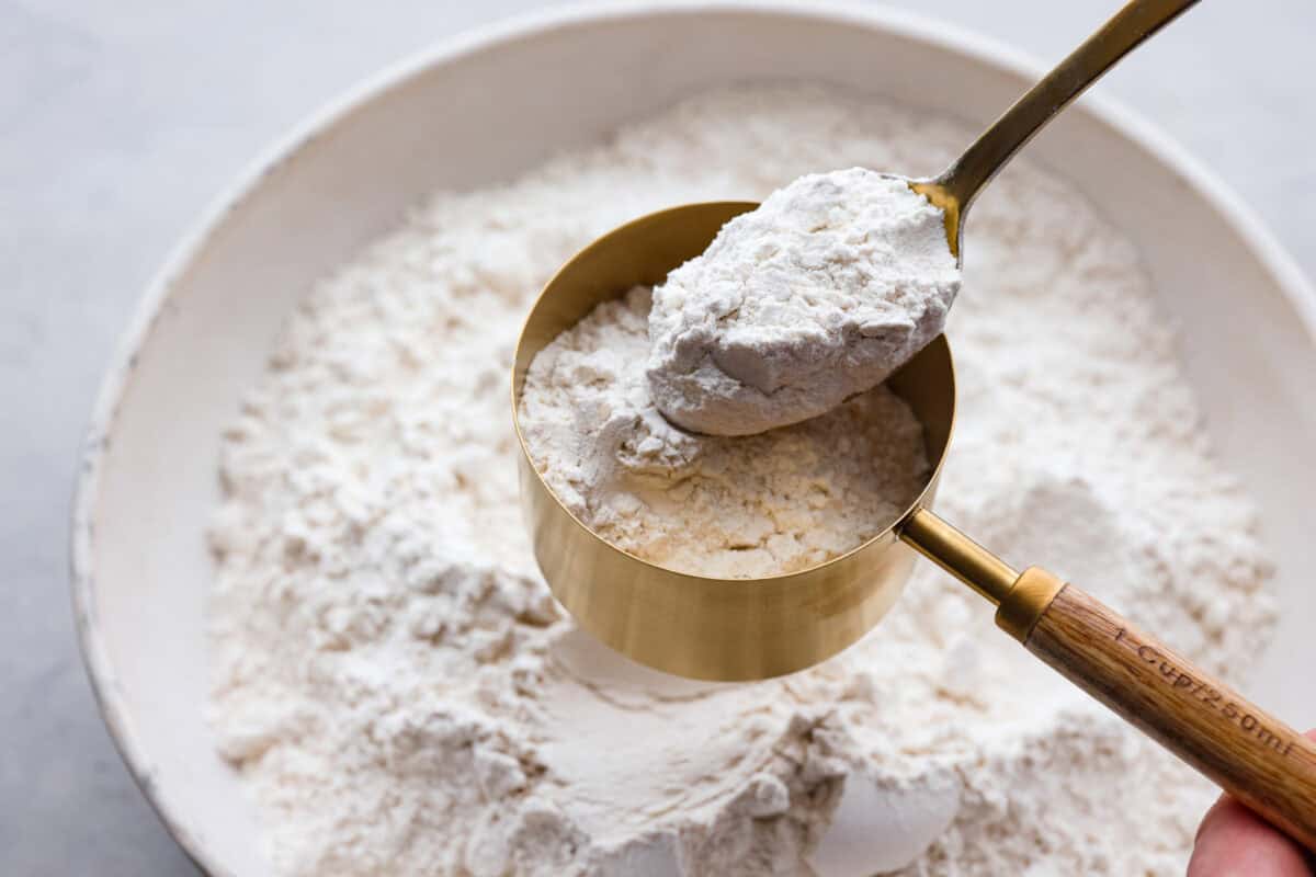 This guide gives you easy swaps that actually work. Save this list and come back to it anytime you need a quick answer! Flour being measured with spoon and a measuring cup.