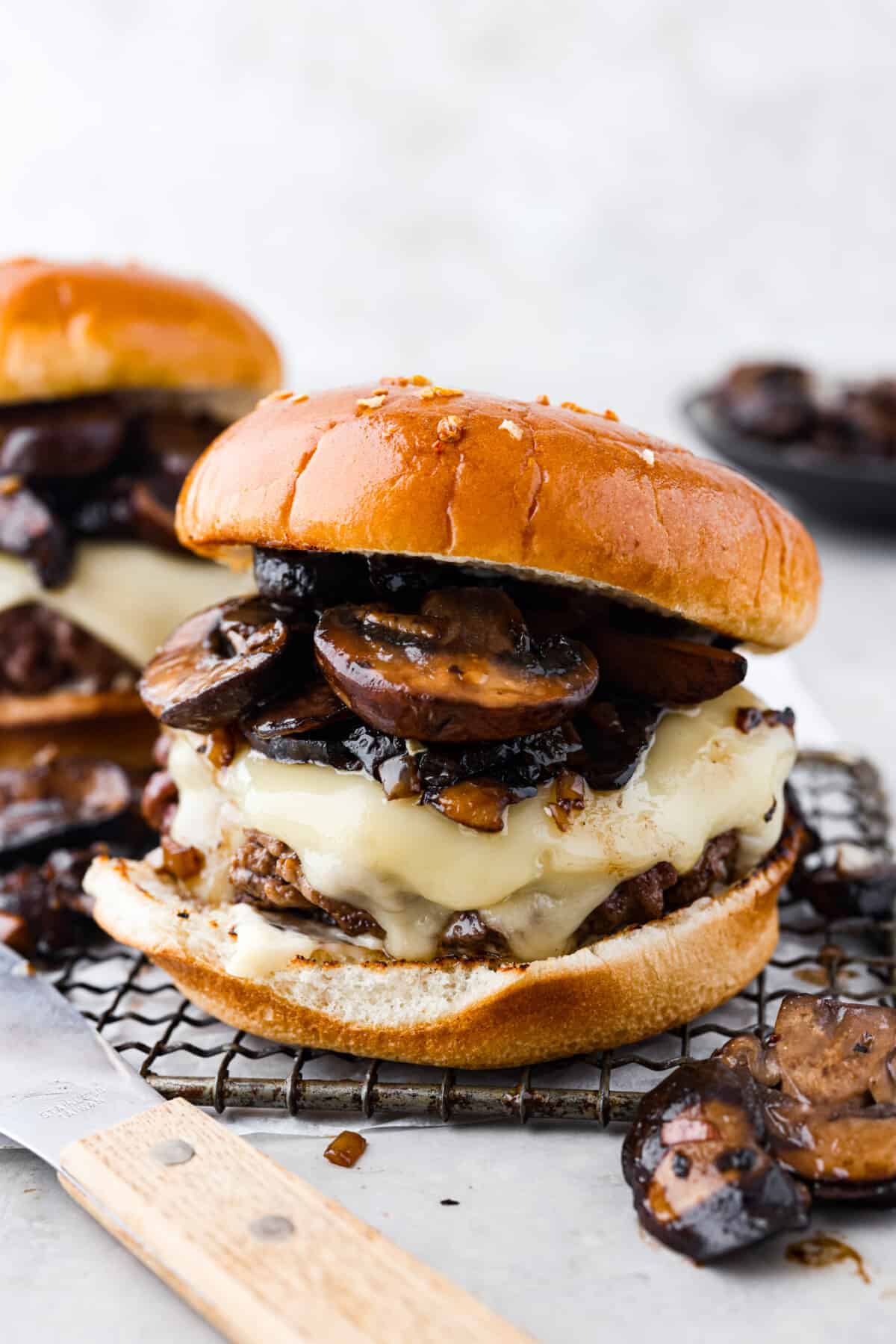 Create the most flavorful, juicy Mushroom Swiss Burger! Perfectly seasoned ground beef is topped with sautรฉed buttery mushrooms and melty Swiss cheese then loaded on fluffy buns for a gourmet burger that's easy to make at home! A Swiss mushroom burger.