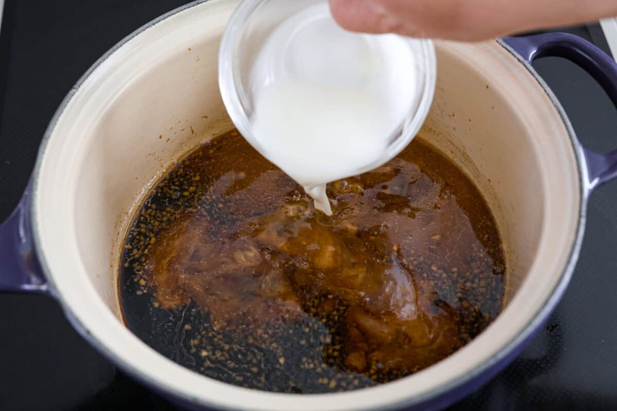 Teriyaki Sauce is super easy, takes only 10 minutes to make and is way better than store-bought! Made with simple ingredients, this is going to become a staple for your kitchen. Cornstarch being added to a saucepan with teriyaki sauce.
