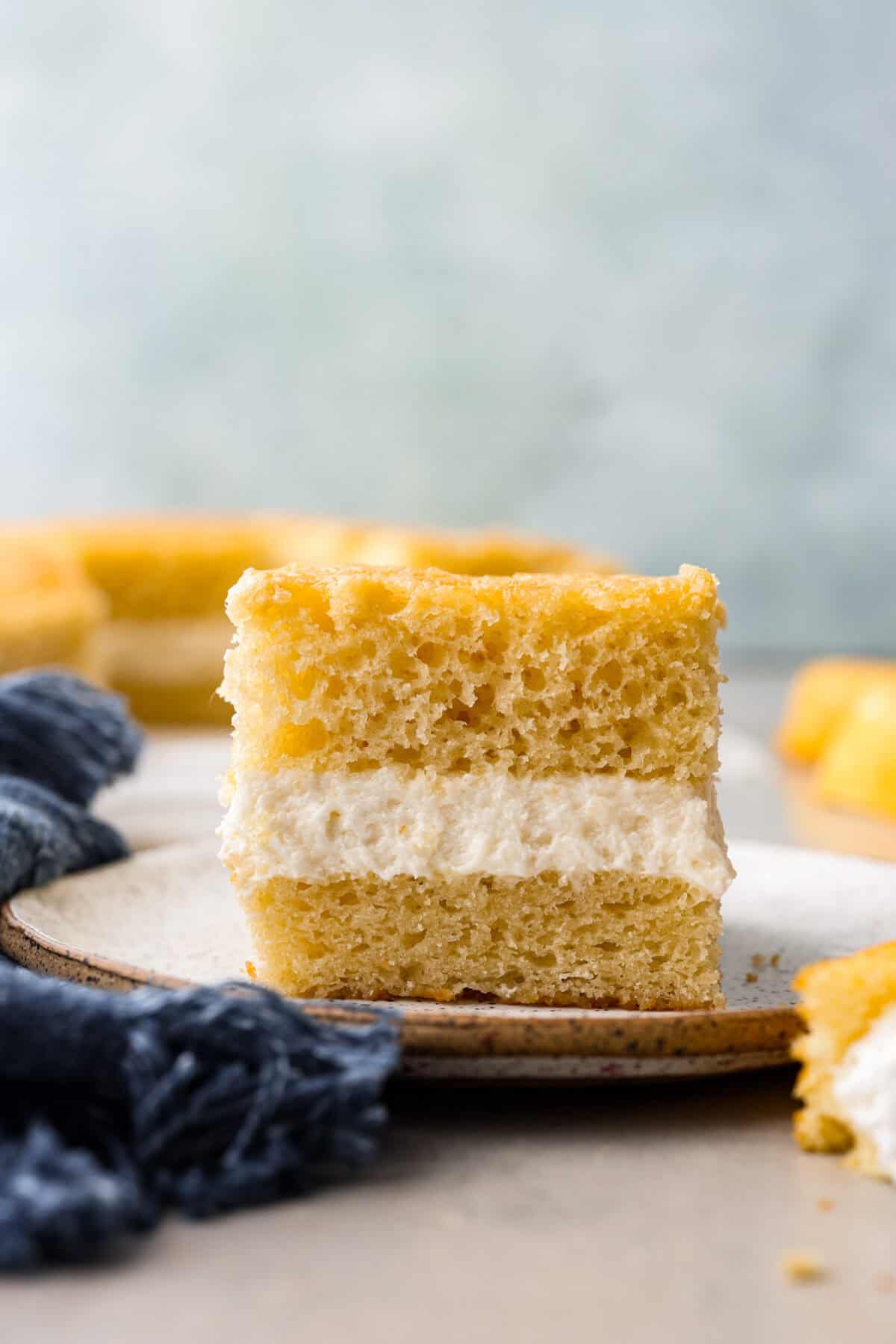 This Twinkie cake is a fun dessert that brings the classic snack cake to life. With its fluffy vanilla sponge and creamy filling, it's sure to be a hit with everyone! A slice of Twinkie cake on a plate.