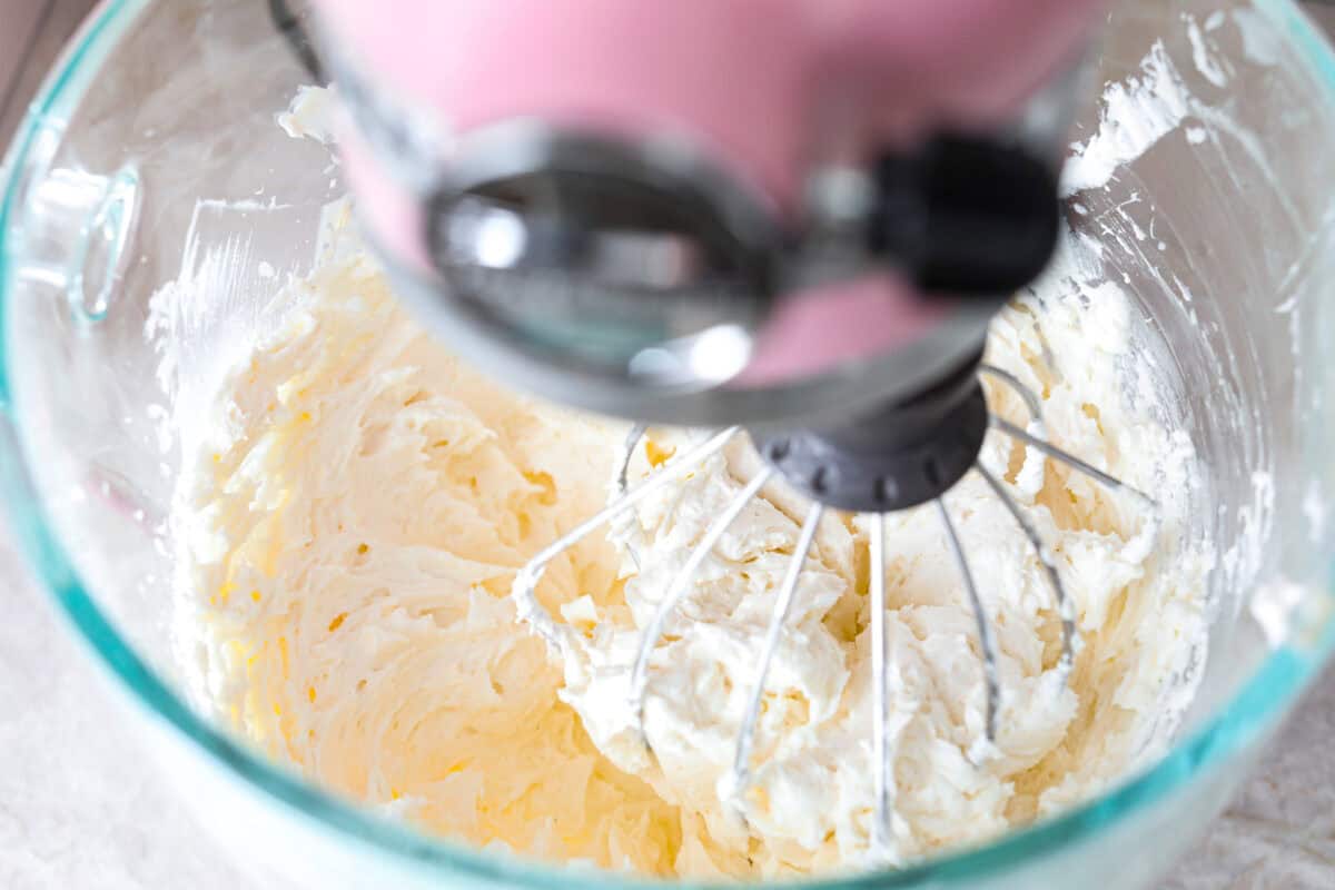 This Twinkie cake is a fun dessert that brings the classic snack cake to life. With its fluffy vanilla sponge and creamy filling, it's sure to be a hit with everyone! The flour past being added to the whipped butter for the Twinkie cake.