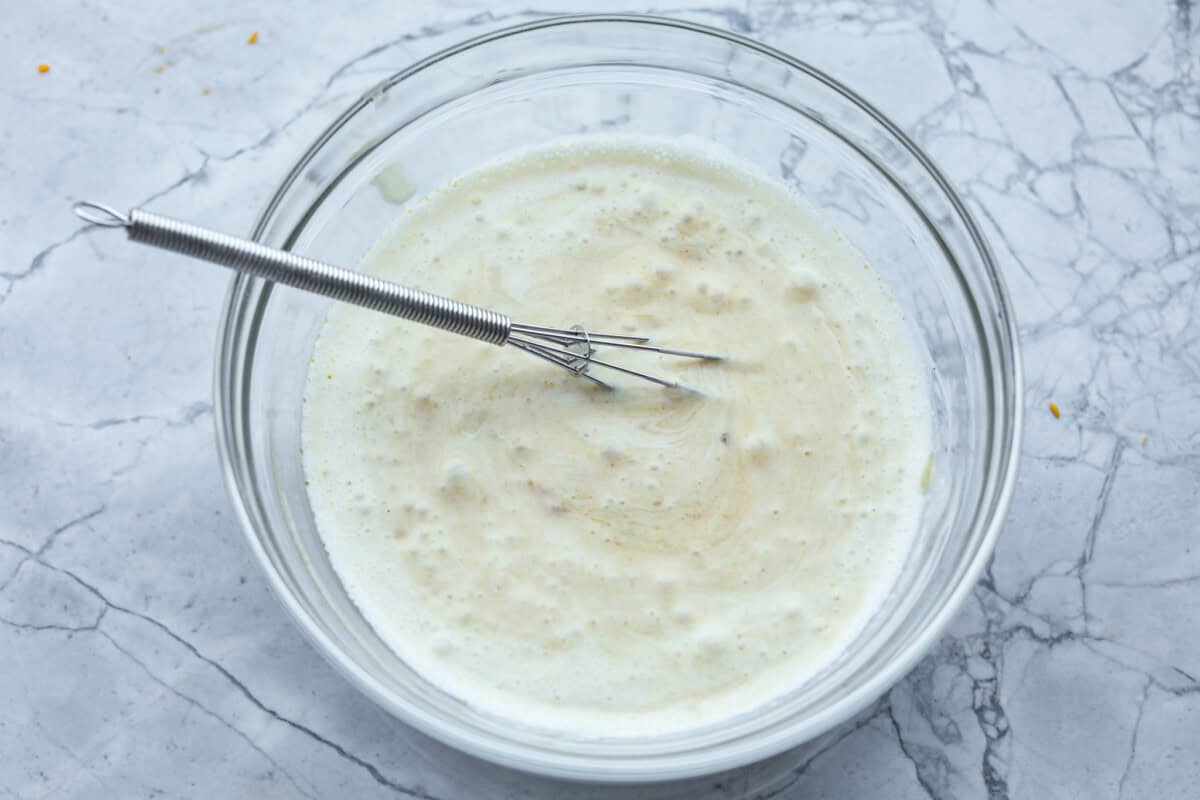 Honey lime chicken enchiladas are a family favorite! These enchiladas are filled with shredded chicken and melty cheese and then smothered in a creamy enchilada sauce. The combination of honey and lime takes these enchiladas to the next level! Fourth photo of the sauce mixed together.