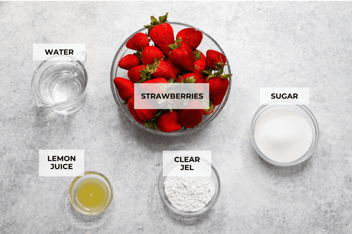 This strawberry pie filling recipe is perfect for anyone who loves a sweet and tangy treat. With easy-to-follow steps and simple ingredients, you'll have a quart of delicious filling ready to enjoy in no time. The top view of ingredients each in individual bowls and labeled.