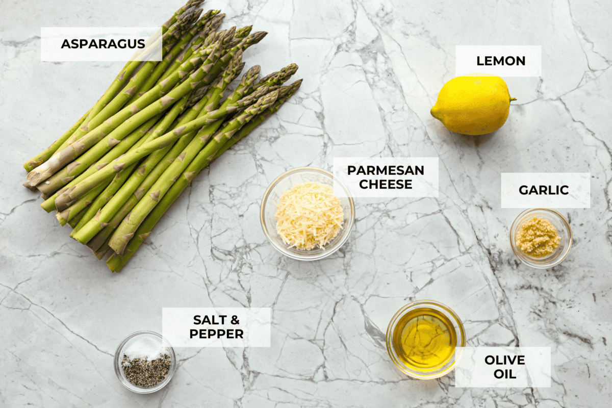 You'll love the combination of flavors in this roasted lemon parmesan garlic asparagus! It's a quick and easy side dish bursting with parmesan, garlic, and a hint of lemon to brighten it all. This is a side that you will make again and again! Ingredients labeled to make roasted lemon parmesan garlic asparagus.