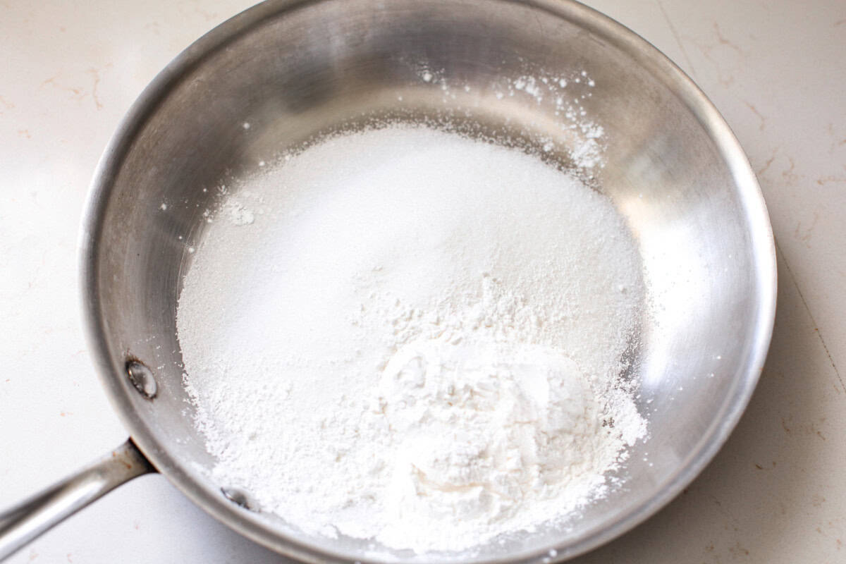 This strawberry pie filling recipe is perfect for anyone who loves a sweet and tangy treat. With easy-to-follow steps and simple ingredients, you'll have a quart of delicious filling ready to enjoy in no time. clear gel and sugar mixed together in a pan.