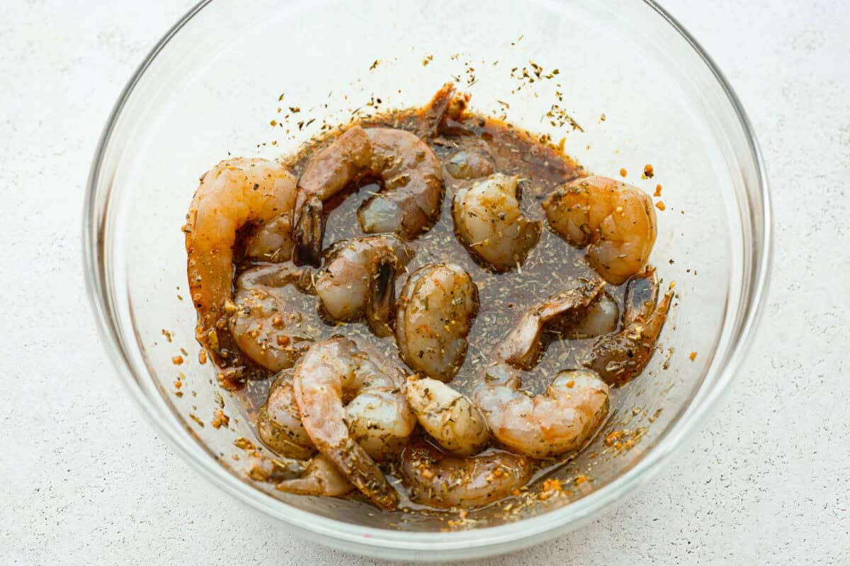 This air fryer shrimp is tender, delicious, and so easy to make! With only a few ingredients, the marinated shrimp cooks to perfection and has the best flavor! Fourth photo of the shrimp marinating.