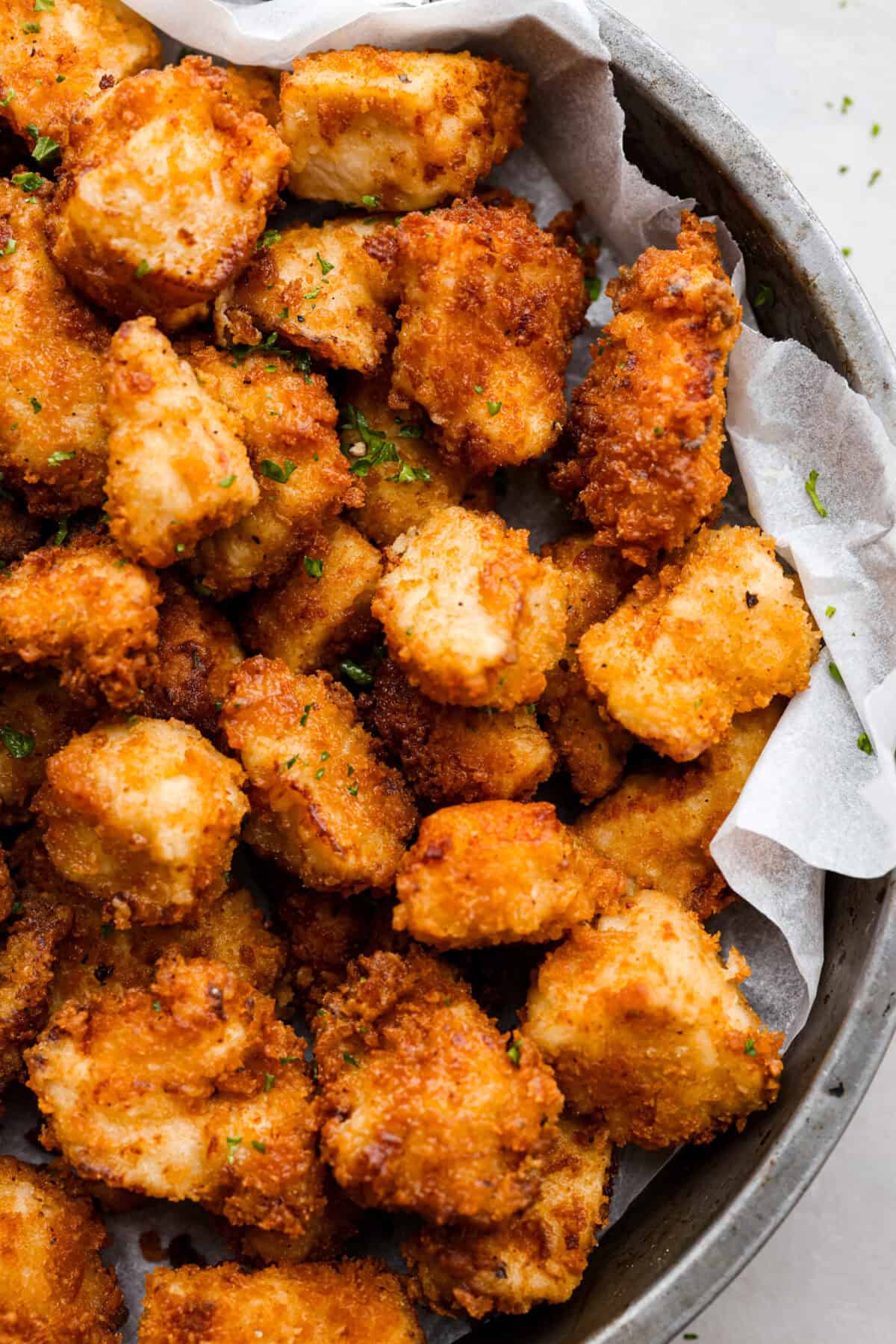 These Chick-fil-A Nuggets taste just like the real thing! They are crispy and salty with the slightest hint of sweetness.ย Pair them with the Chick-fil-A sauce and make the perfect family meal! A close up of chick-fil-a nuggets on a platter.