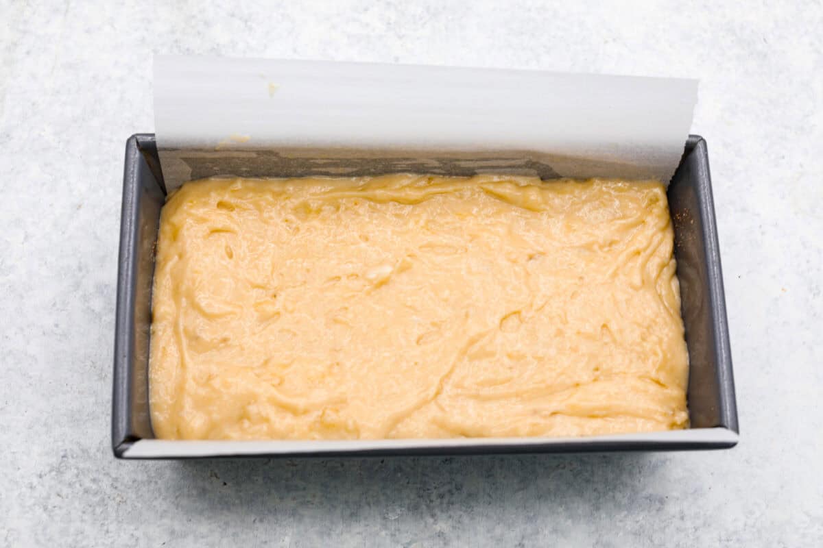 Cinnamon Swirl Banana Bread is a delightful twist on the classic. What sets this recipe apart is the luscious cinnamon sugar swirl running through the middle and on top, creating a beautiful marbled effect and an extra burst of flavor. It's irresistibly delicious! Overhead shot of batter in pan.
