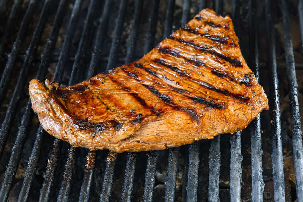 Close up shot of raw tri-tip in large zip-loc with marinade being poured over it. Angle shot of grilled tri-tip.