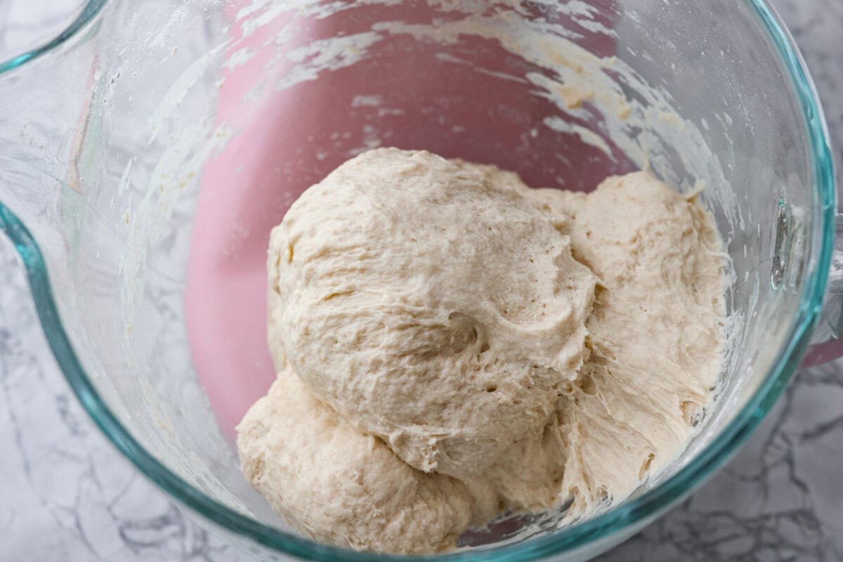 You want to make bread, but where do you start? My beginner's guide to baking bread is here to save the day! Feel confidentย at bread-making while I hold your hand through the whole process. Second photo of mixed dough in a mixer.
