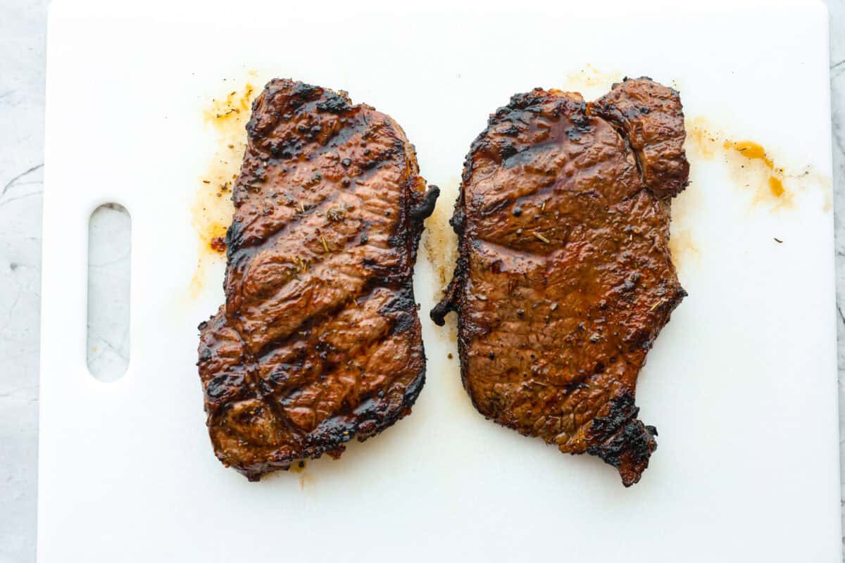 Fire up your grill because these grilling basics will give you all the confidence you need! Discover how easy it is to cook, entertain, and make incredible food on an outdoor grill. Third photo of two steaks resting before slicing.