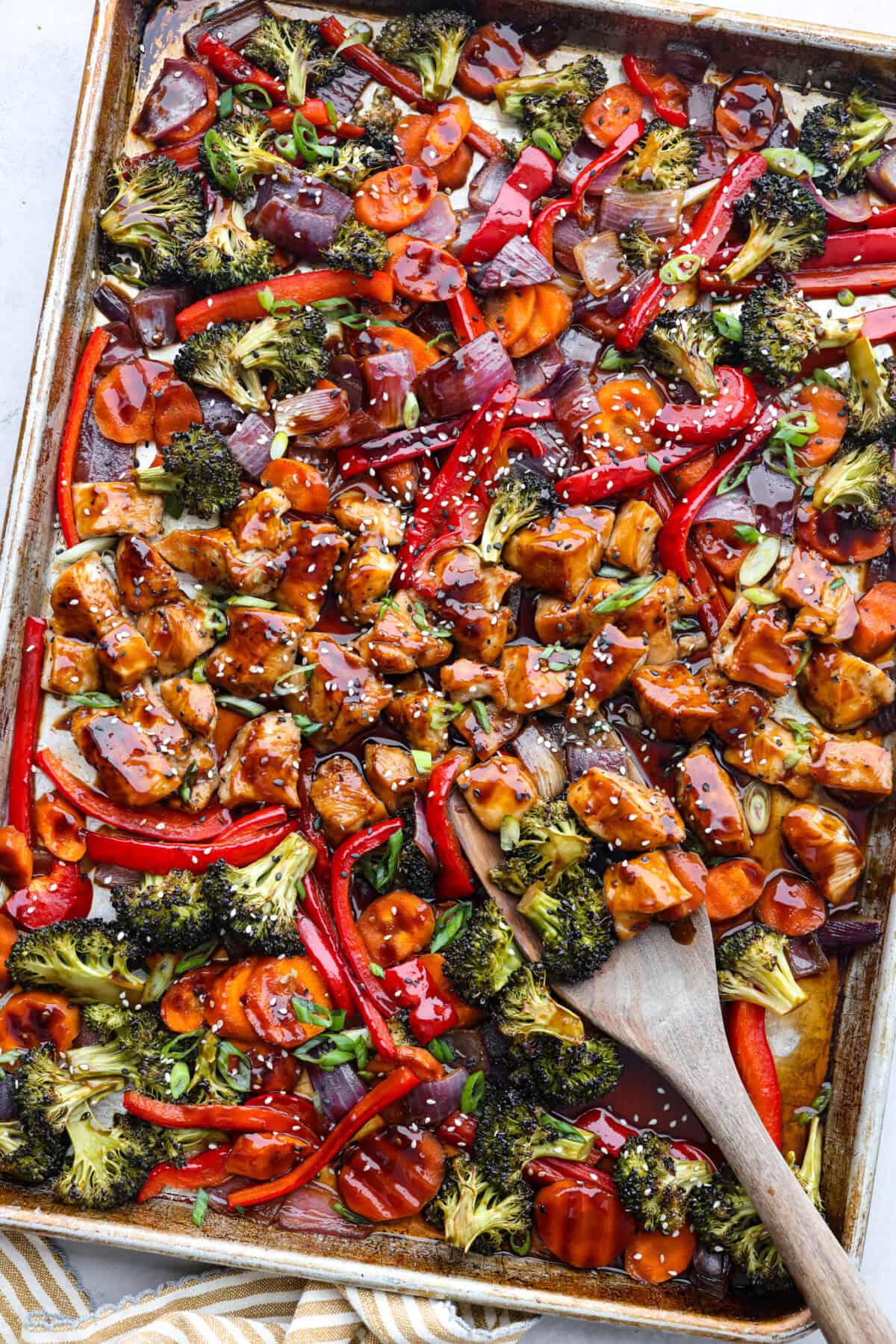 This sheet pan teriyaki chicken with vegetables is a family favorite! It's loaded with tender chicken and veggies that get tossed in a homemade teriyaki sauce. A one pan dinner recipe that is super easy to throw together. Top view of sheet pan teriyaki chicken with vegetables.