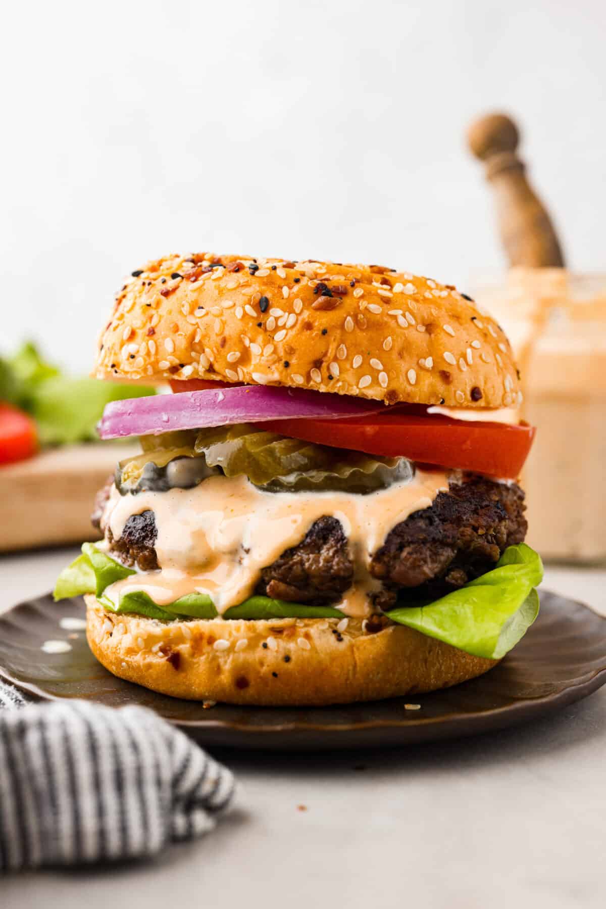 Get ready for the ultimate burger experience topped with my irresistible Secret Sauce. The flavor packed into this burger is a delicious twist on a classic favorite. A burger ready to eat loaded with sauce and toppings.