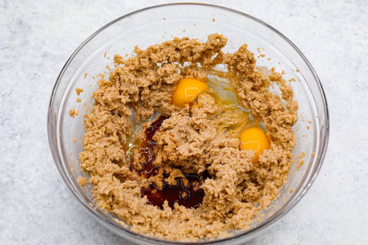 Satisfy your sweet tooth with loaded Biscoff Cookies. They are soft and chewy and infused with the flavor of Biscoff cookies and cookie butter. These are easy to whip up and will be a hit for any occasion! Overhead shot of the creamed butter and sugar in a bowl with eggs and vanilla added.