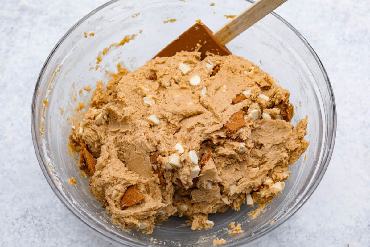 Satisfy your sweet tooth with loaded Biscoff Cookies. They are soft and chewy and infused with the flavor of Biscoff cookies and cookie butter. These are easy to whip up and will be a hit for any occasion! Overhead shot of a bowl of fully incorporated cookie dough.