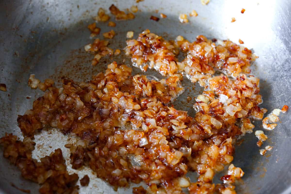 The Best French Onion Dip begins with caramelized onions that combine with cream cheese, sour cream, and seasonings. It creates a dip so addictive and creamy, it'll be gone before you know it! Second photo of caramelized onions in a pan.