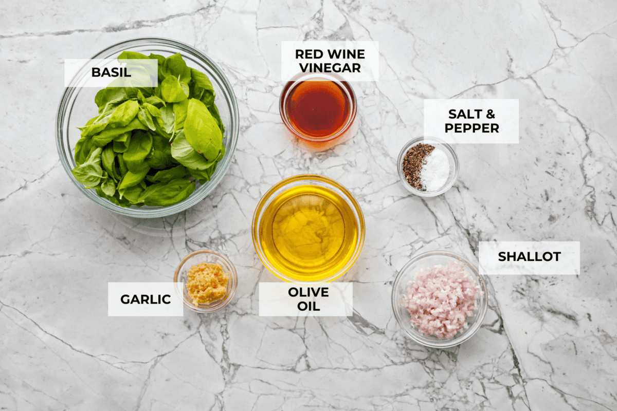 Basil Vinaigrette is a versatile dressing made from a few fresh ingredients. It is bursting with flavor and can be used on salads, as a marinade, or as a sauce for various dishes. It will be a great addition to your repertoire of homemade dressings. Overhead shot of labeled ingredients.