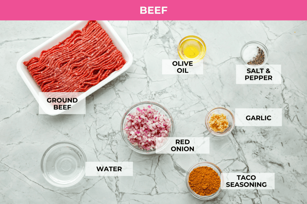 Beef taco salad is a delicious and simple family favorite, perfect for summer evenings! Packed with your favorite taco essentials like beans, corn, avocado, and fresh cilantro, it's bursting with flavor and sure to become a staple dish! Overhead shot of labeled ingredients for beef.