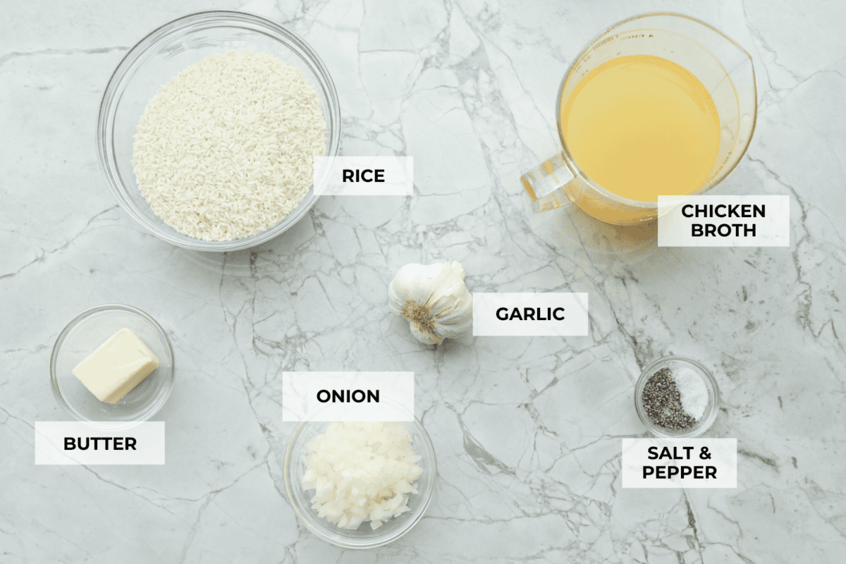 Garlic Butter Rice is the perfect side dish for dinner! A simpleย mix of butter, sautรฉed onion, garlic, and chicken brothย gives this rice tons of great flavor. It's easy to make and tastes amazing! Overhead shot of labeled ingredients.