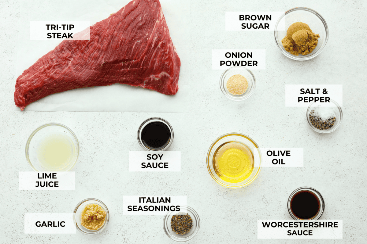 Grilled Tri-Tip is a flavorful, juicy steak that will be the star of your barbecue! It's marinated in a simple, yet tasty marinade, then grilled to perfection. Serve with my sweet and savory chimichurri sauce and your favorite sides for an impressive meal that everyone will love! Overhead shot of labeled ingredients in separate bowls.