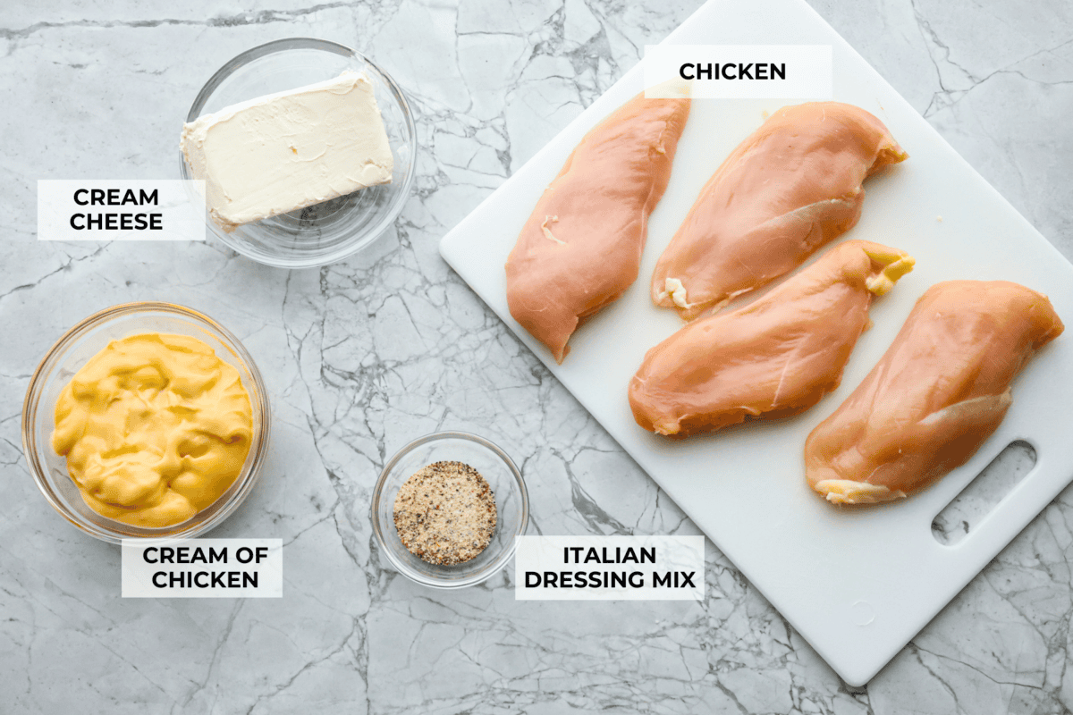 Italian cream cheese chicken is a simple way to enjoy tender, creamy, flavorful chicken over noodles, rice, or potatoes. With only four ingredients, this is definitely one of those slow cooker recipes you will have on repeat. Overhead shot of labeled ingredient.