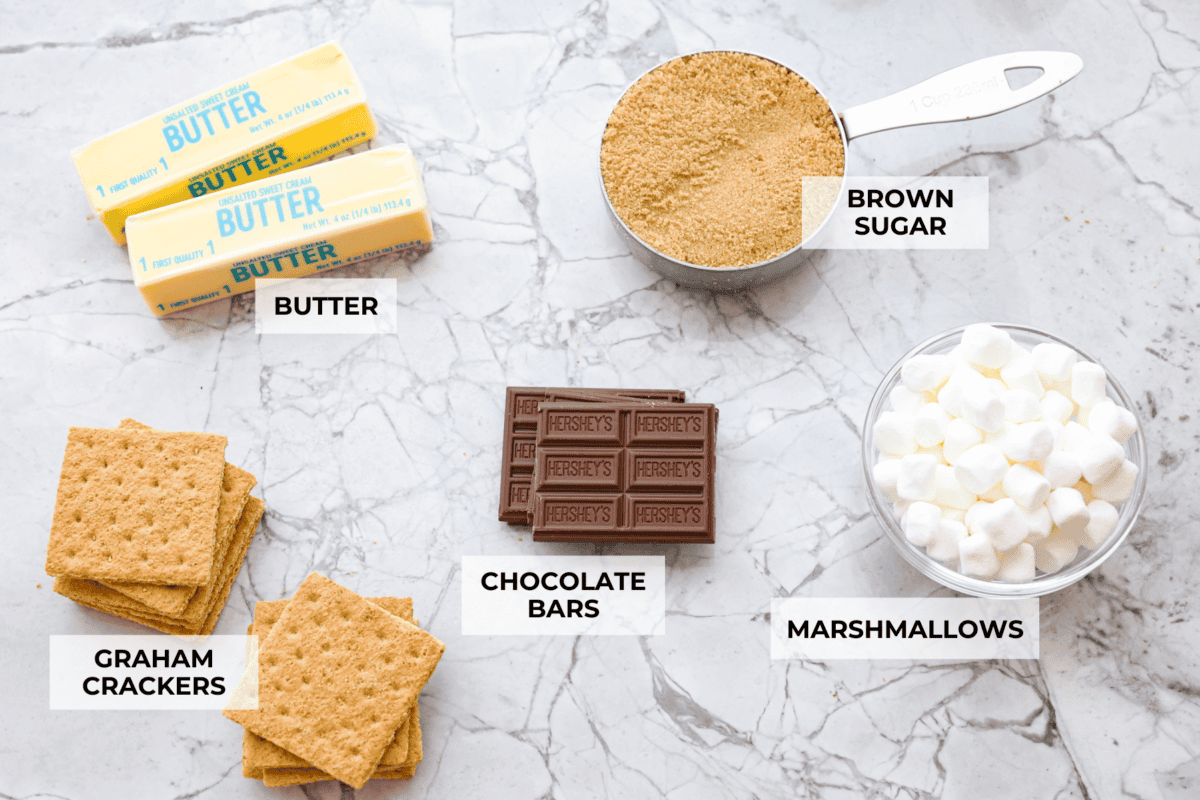 S'mores crack is a quick way to enjoy the classic s'more experience without a campfire. Featuring a buttery graham cracker crust, rich melted chocolate, and toasted marshmallows, this treat will quickly become a family favorite. Overhead shot of ingredients with labels.