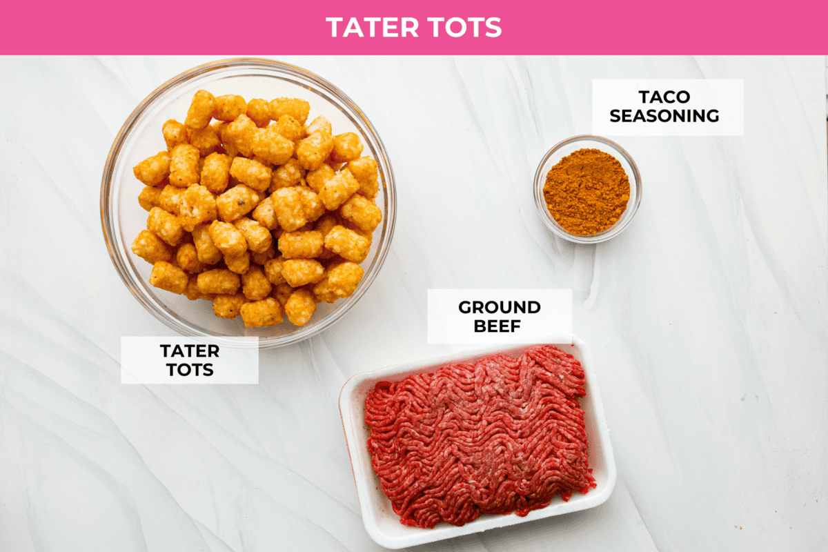 Tater Tot Nachos (Totchos) are made with crispy golden tater tots, topped with seasoned beef, scoops of refried beans, corn, black beans, salsa and melty cheese. Add your favorite toppings and dig in! overhead shot of labeled tater tot nacho ingredients.