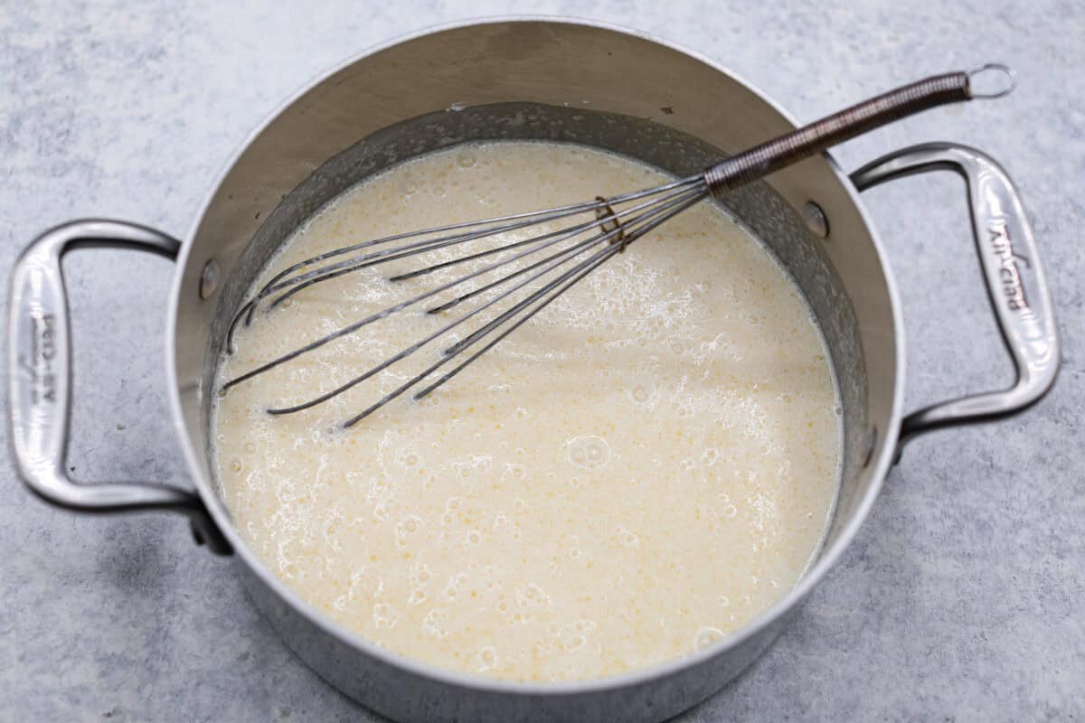 Sugar cream pie, or Hoosier pie, is a creamy, delicious treat with deep roots in the Midwest, especially in Indiana. You can top it however you like, serve it warm, at room temperature, or even chilled. Give this simple recipe a go. I know youโll love it! Overhead shot of pie filling ingredients in a pot with a whisk.