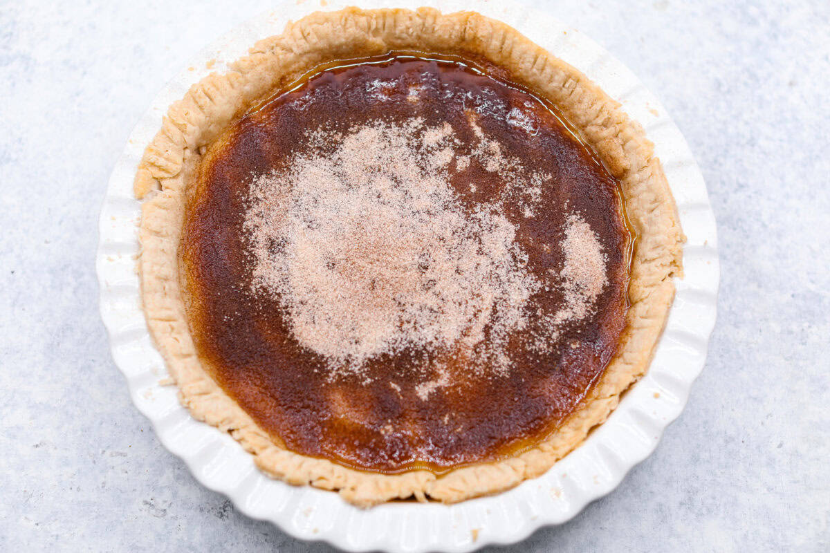 Sugar cream pie, or Hoosier pie, is a creamy, delicious treat with deep roots in the Midwest, especially in Indiana. You can top it however you like, serve it warm, at room temperature, or even chilled. Give this simple recipe a go. I know youโll love it! Overhead shot of pie before it has been placed in the oven with cinnamon sugar mixture over the top.