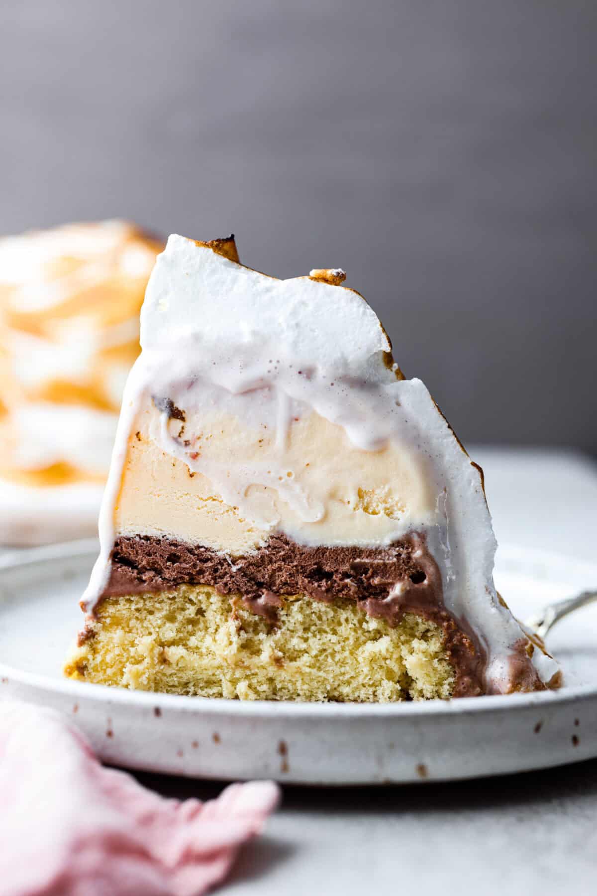 Side shot of a plated slice of baked Alaska.