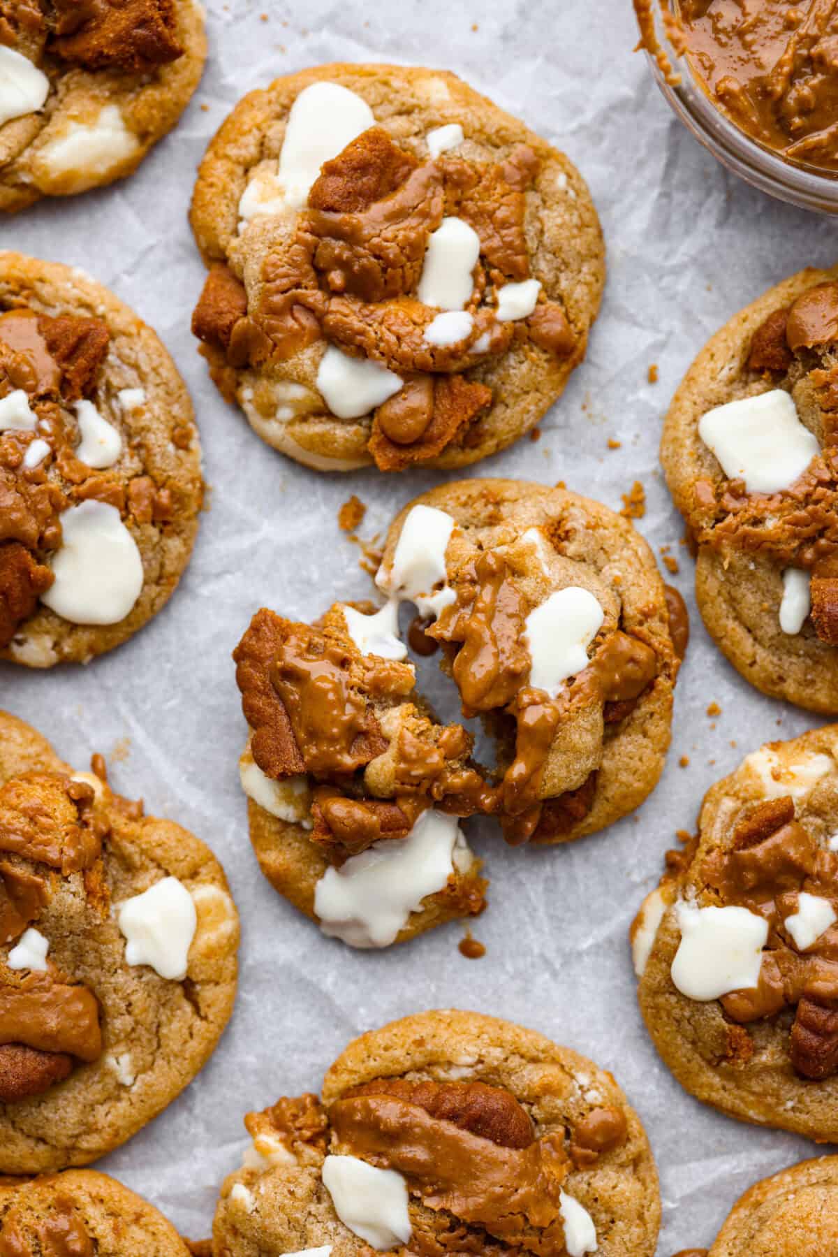 Satisfy your sweet tooth with loaded Biscoff Cookies. They are soft and chewy and infused with the flavor of Biscoff cookies and cookie butter. These are easy to whip up and will be a hit for any occasion! Close up shot of baked Biscoff cookies on a cookie sheet.