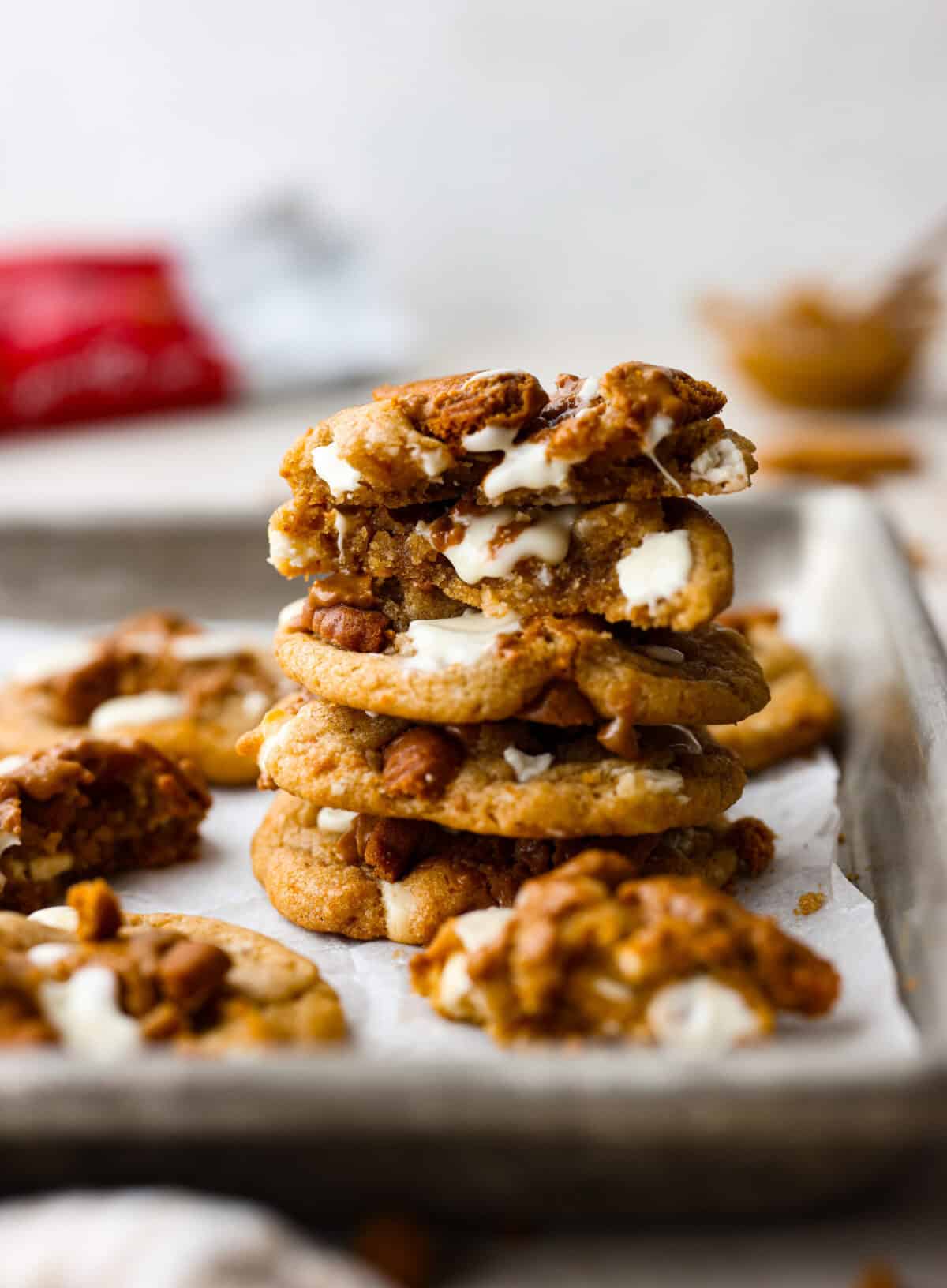 Satisfy your sweet tooth with loaded Biscoff Cookies. They are soft and chewy and infused with the flavor of Biscoff cookies and cookie butter. These are easy to whip up and will be a hit for any occasion! Side shot of stacked Biscoff cookies.