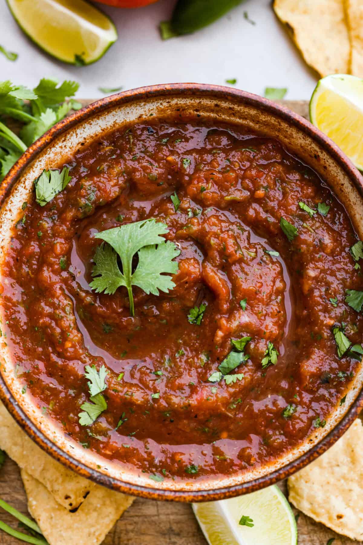 Best Blender Salsa is restaurant-quality salsa that is made right in your blender! It only takes 5 minutes and is truly the very best out there! This vibrant and refreshing salsa has the perfect blend of sweet, spicy elements. Close up shot of salsa in bowl.