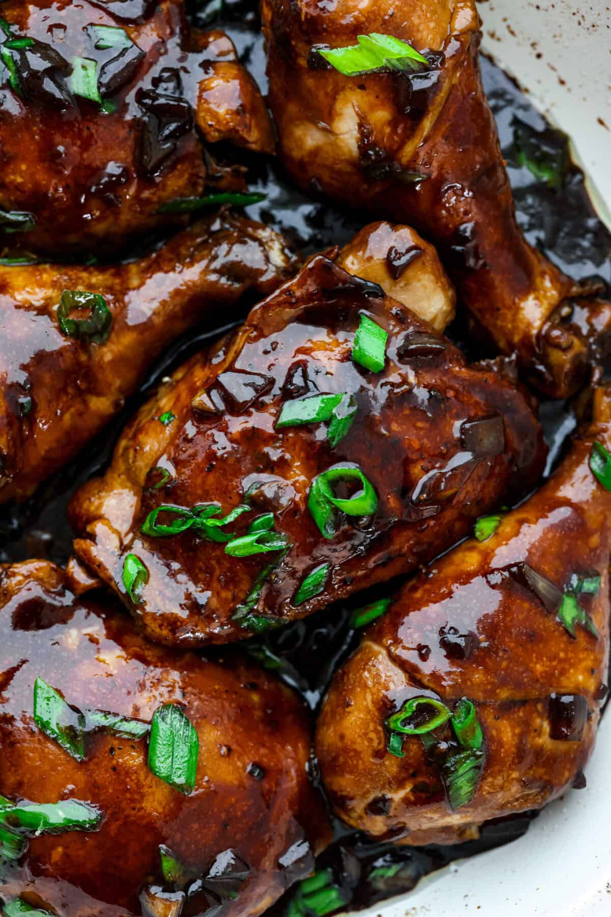 Chicken Adobo is a tangy, salty, sweet, and spicy Filipino dish. This meal is easy to make and requires just a few simple ingredients. It's sure to become a family favorite! Close up shot of chicken adobo.