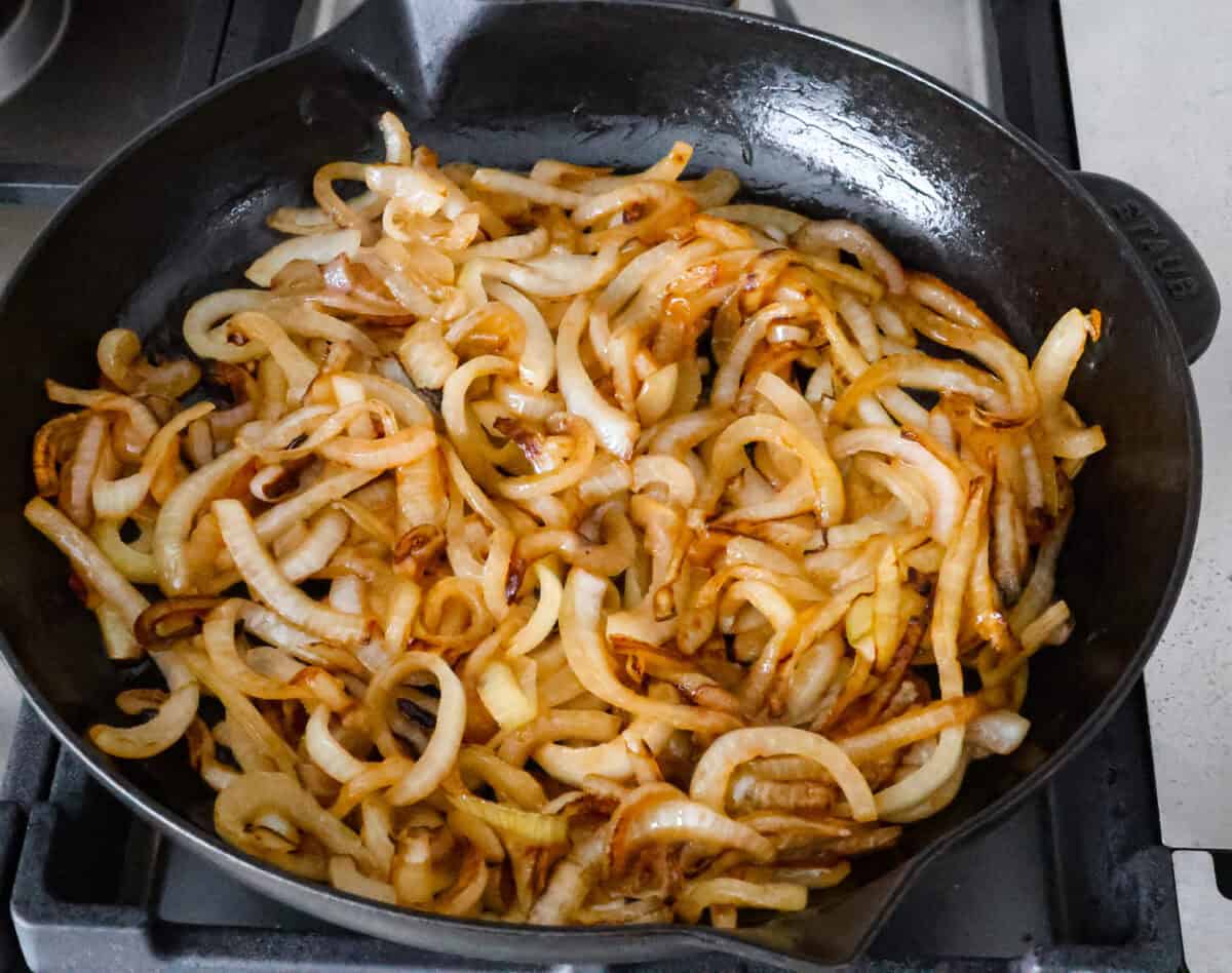 Skillet French Onion Chicken delivers a tender and creamy chicken dinner that you can make at home, it's easily better than anything you can find in a restaurant. Your family will love this incredibly delicious meal, making it an instant favorite! Overhead shot of grilled onion in skillet.