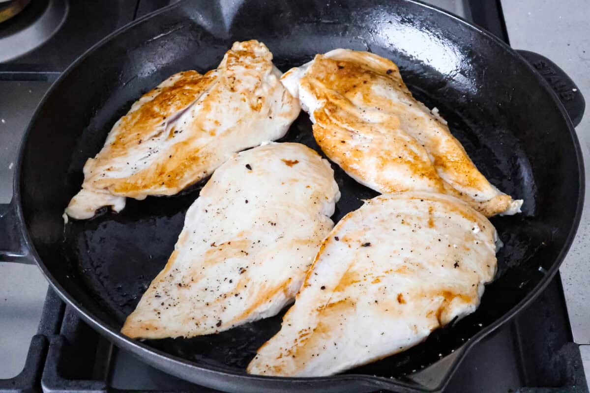 Skillet French Onion Chicken delivers a tender and creamy chicken dinner that you can make at home, it's easily better than anything you can find in a restaurant. Your family will love this incredibly delicious meal, making it an instant favorite! Overhead shot grilled chicken in a skillet.