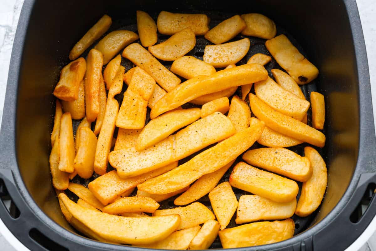 The air fryer is one of the most versatile appliances in today's kitchen! Learn how to use an air fryer to cook, reheat, and achieve that "fried" texture without frying in oil. Once you cook in the air fryer you will never look back! Second photo of cooked French fries in the air fryer.