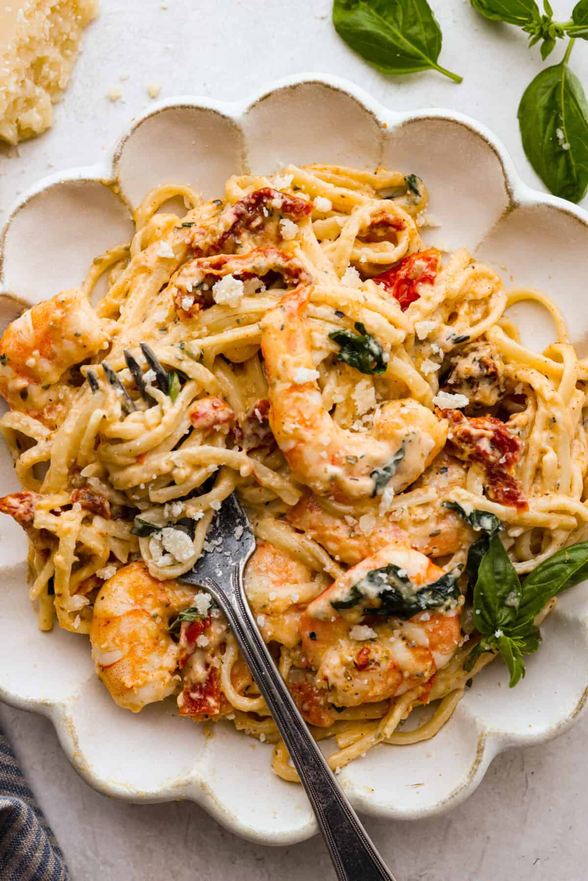 Marry Me Shrimp Pasta dazzles with robust Italian flavors. It's ready in just 30 minutes, and the creamy sauce, brimming with fresh herbs and spices, could very well lead to a marriage proposal after your first bite! Overhead shot of plated marry me shrimp with pasta.