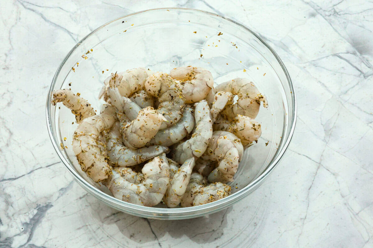 Marry Me Shrimp Pasta dazzles with robust Italian flavors. It's ready in just 30 minutes, and the creamy sauce, brimming with fresh herbs and spices, could very well lead to a marriage proposal after your first bite! Overhead shot of a bowl of raw seasoned shrimp.