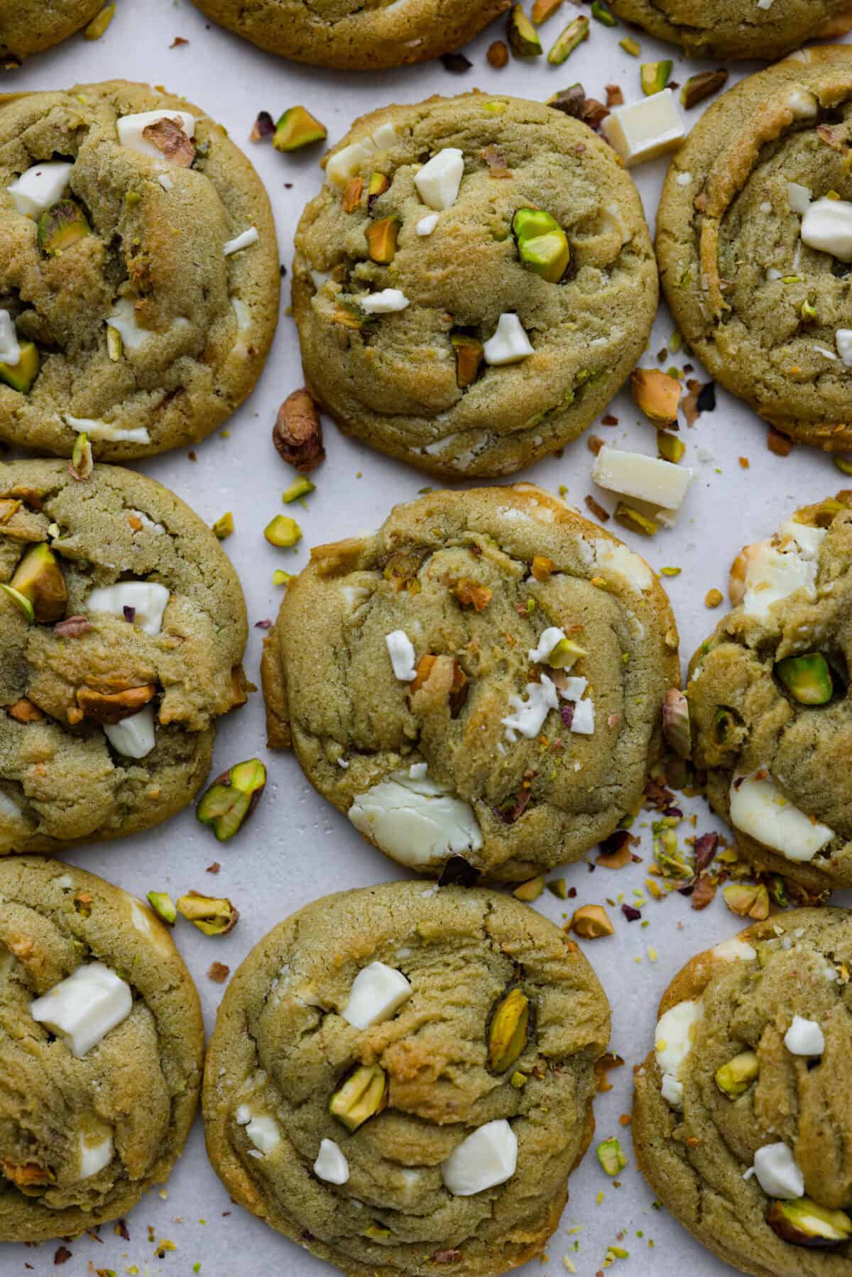 Pistachio Pudding Cookies are super soft, chewy, and irresistible! They're easy to make, and adding pistachio pudding mix gives this cookie recipe wonderful flavor and the perfect tender texture! close up overhead shot of baked pistachio pudding cookies.