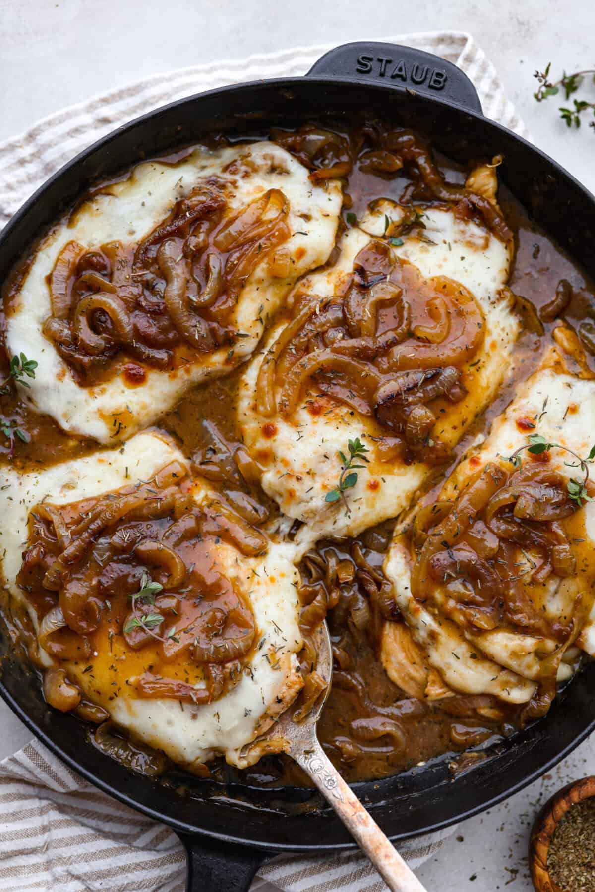 Skillet French Onion Chicken delivers a tender and creamy chicken dinner that you can make at home, it's easily better than anything you can find in a restaurant. Your family will love this incredibly delicious meal, making it an instant favorite! Overhead shot of finished french onion chicken.